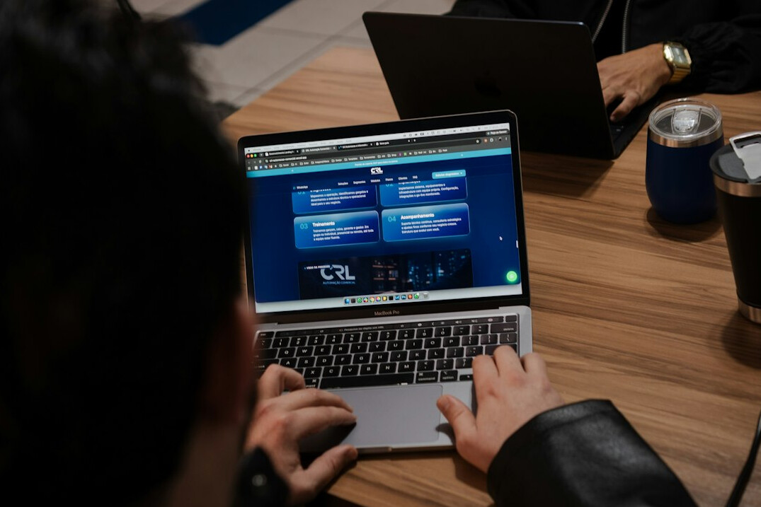person writing code on laptop
